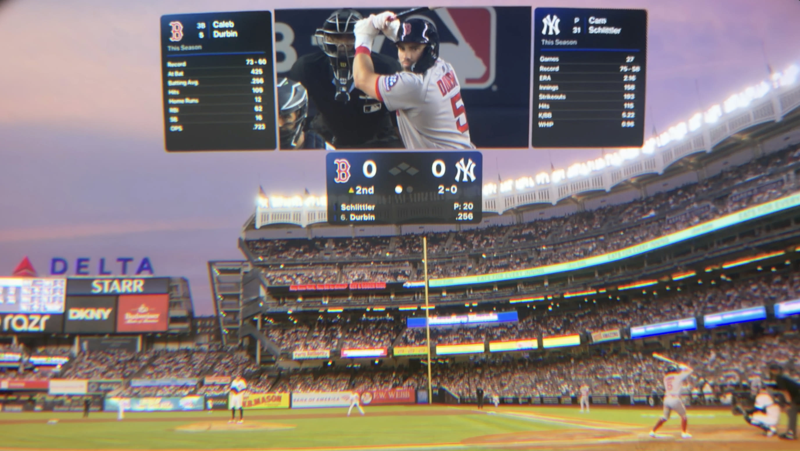 Field-level view of Red Sox–Yankees in Apple Immersive with a floating broadcast, score, and player statistics above Yankee Stadium