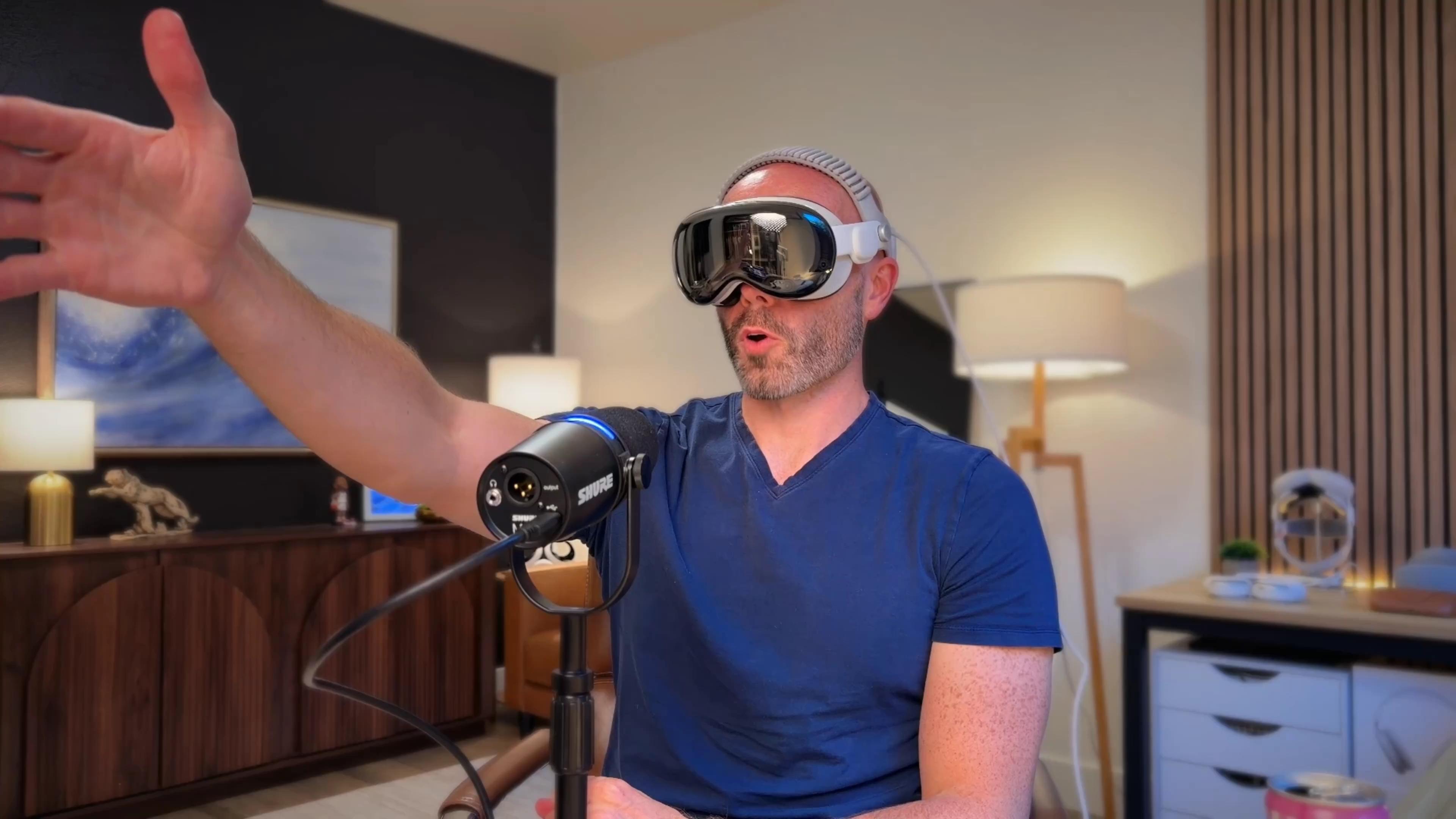 Justin Ryan wears Apple Vision Pro and raises one hand while reacting to Red Sox–Yankees in Apple Immersive