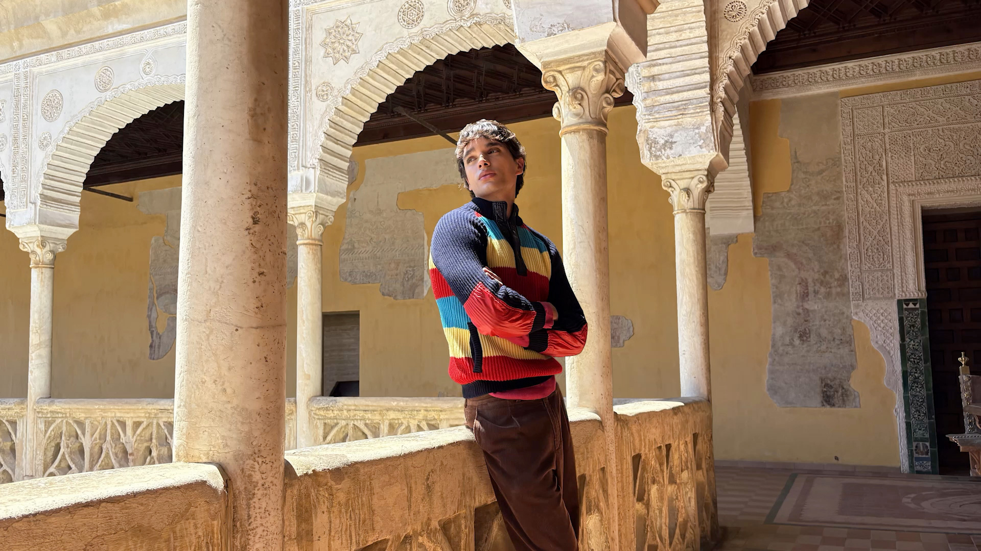 An Apple spatial scene showing a person among the arches of a sunlit courtyard