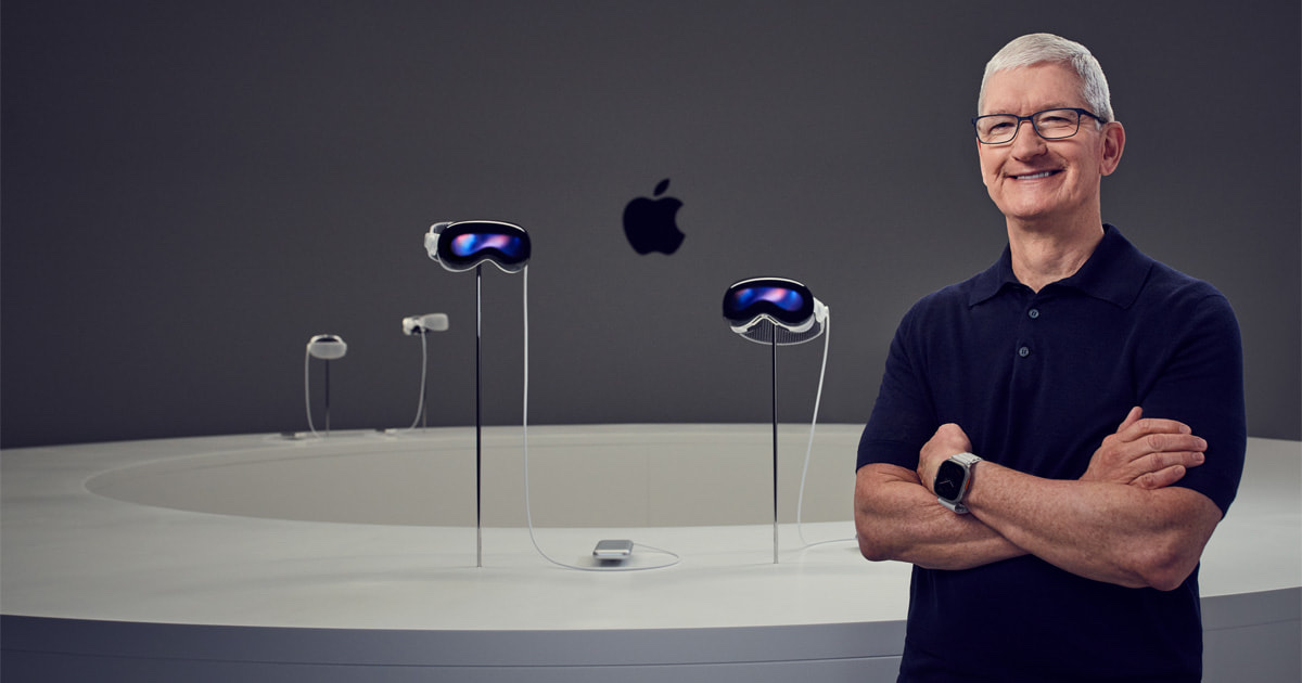 Tim Cook stands beside the first Apple Vision Pro display at WWDC23