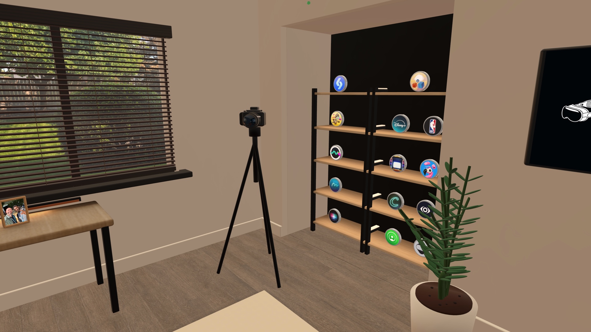 A camera on a tripod beside wood shelves filled with round app icons inside the Spatial Insider studio