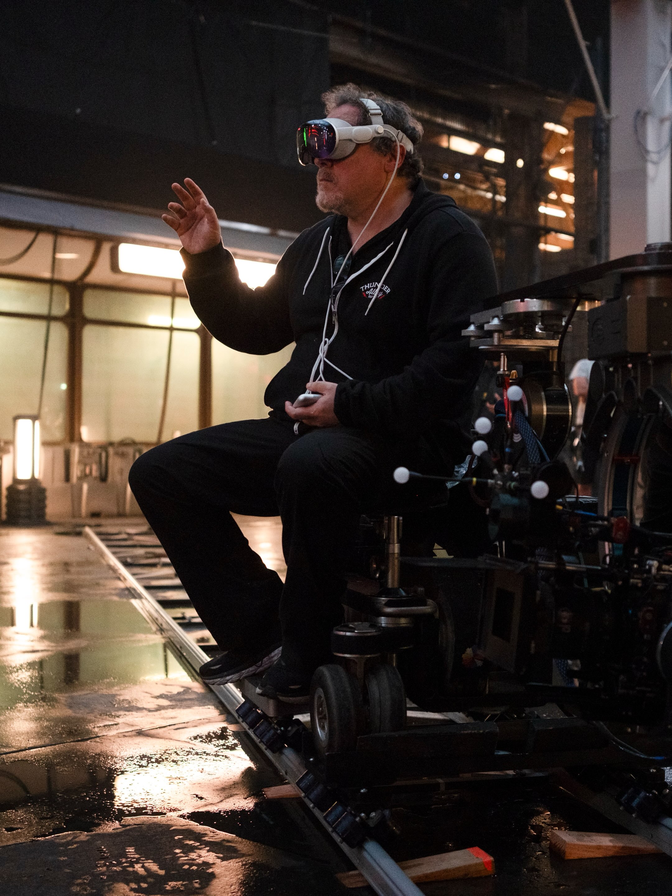 Jon Favreau wearing Apple Vision Pro while sitting on a camera dolly on the set of The Mandalorian and Grogu