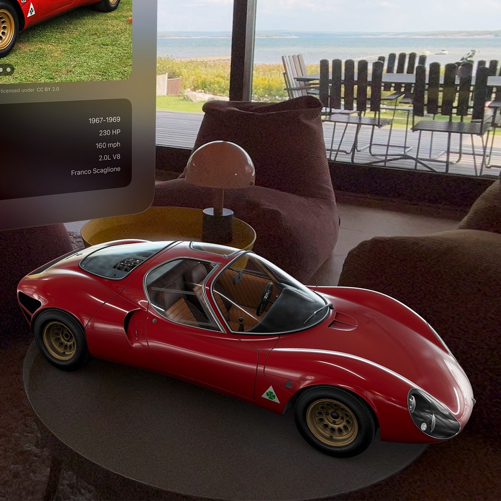 A red Alfa Romeo Tipo 33 Stradale model displayed on a table in a living room in Caradise on Apple Vision Pro