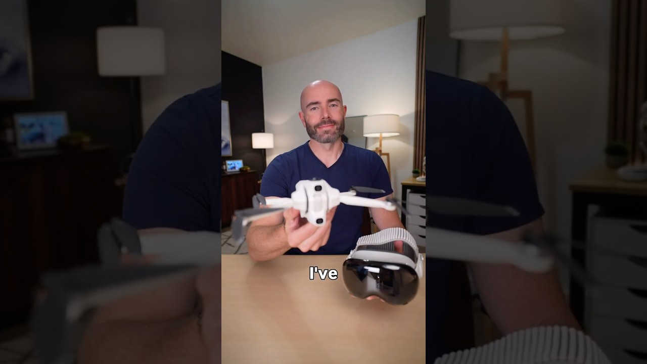 Justin holding a drone beside Apple Vision Pro