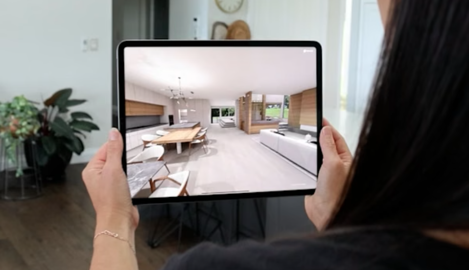 A person holding a tablet displaying an Enviz home walkthrough