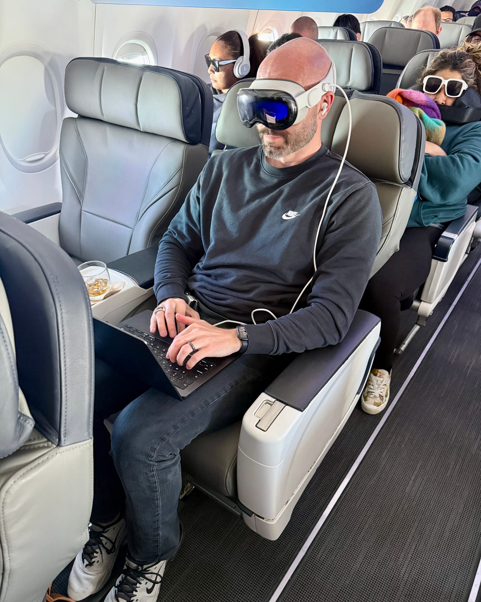 Justin Ryan working from a premium airplane cabin