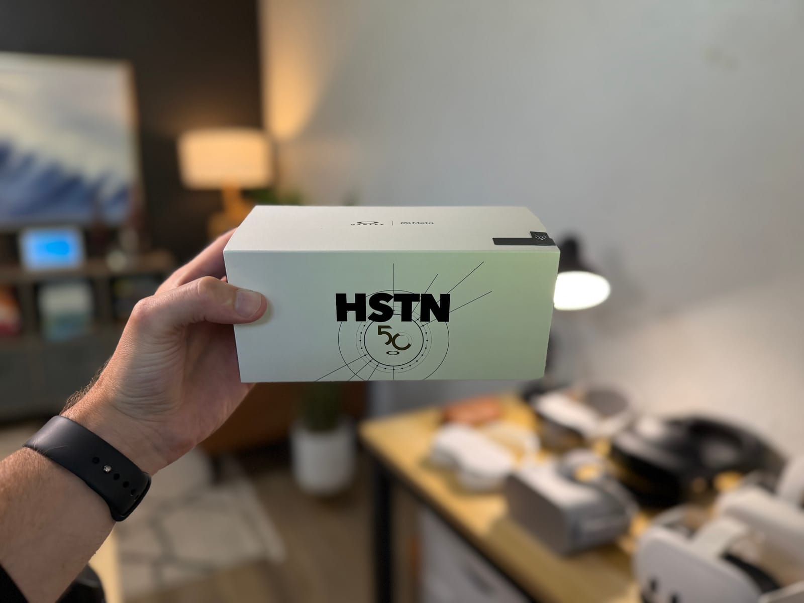 An Oakley Meta HSTN smart glasses box held during hands-on testing