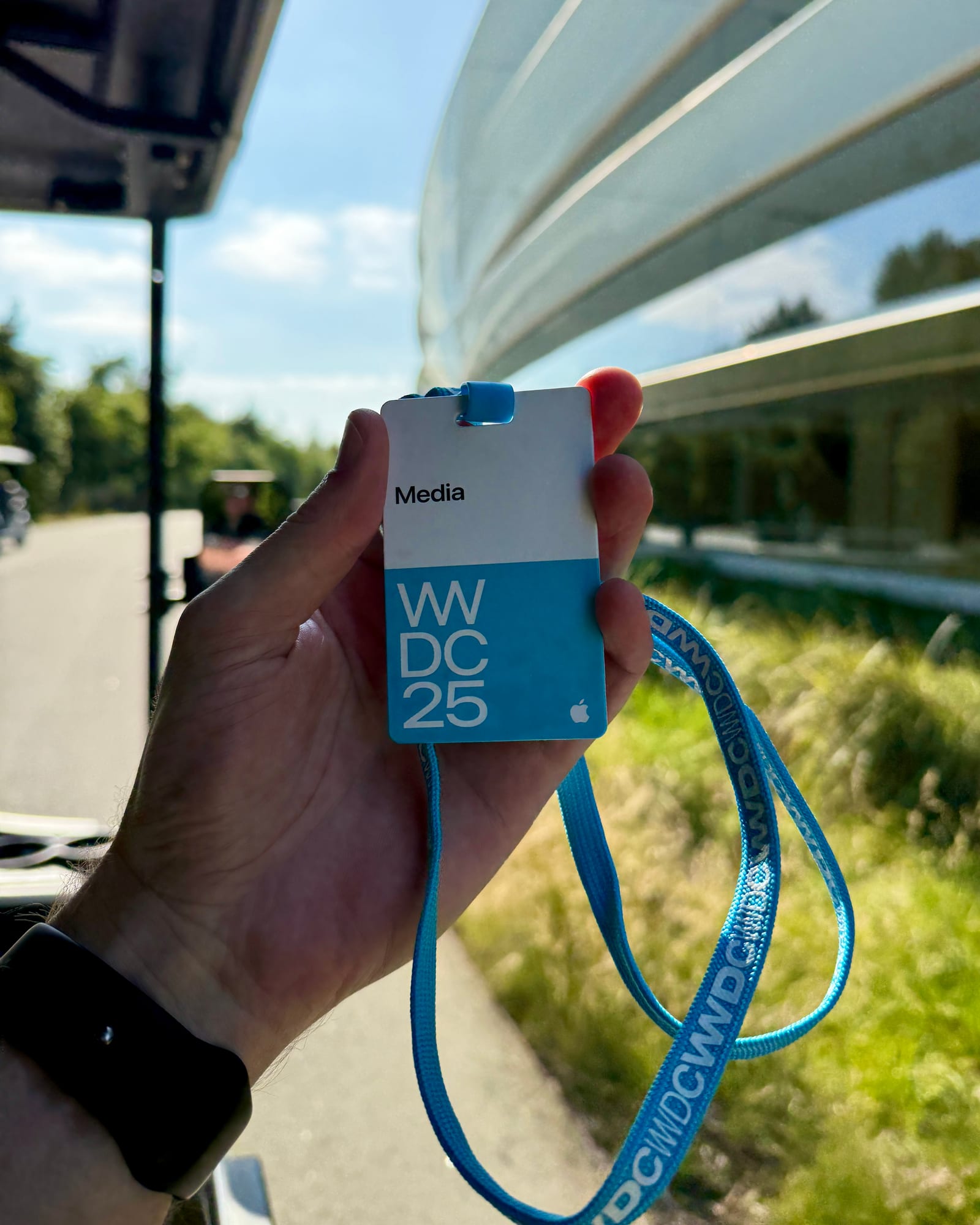 A Spatial Insider media badge outside Apple Park during WWDC25