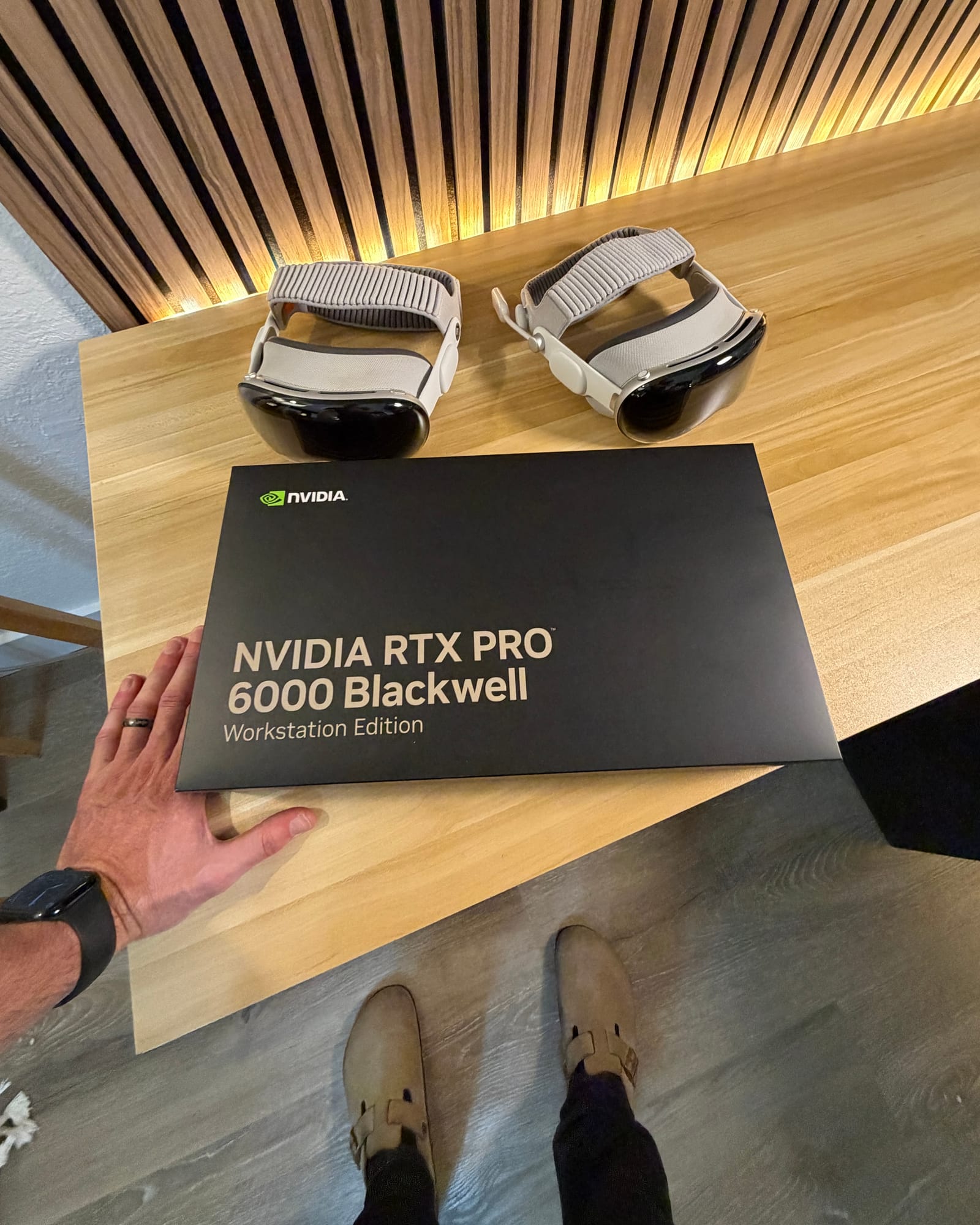 Two Apple Vision Pro headsets beside an NVIDIA RTX Pro Blackwell workstation box