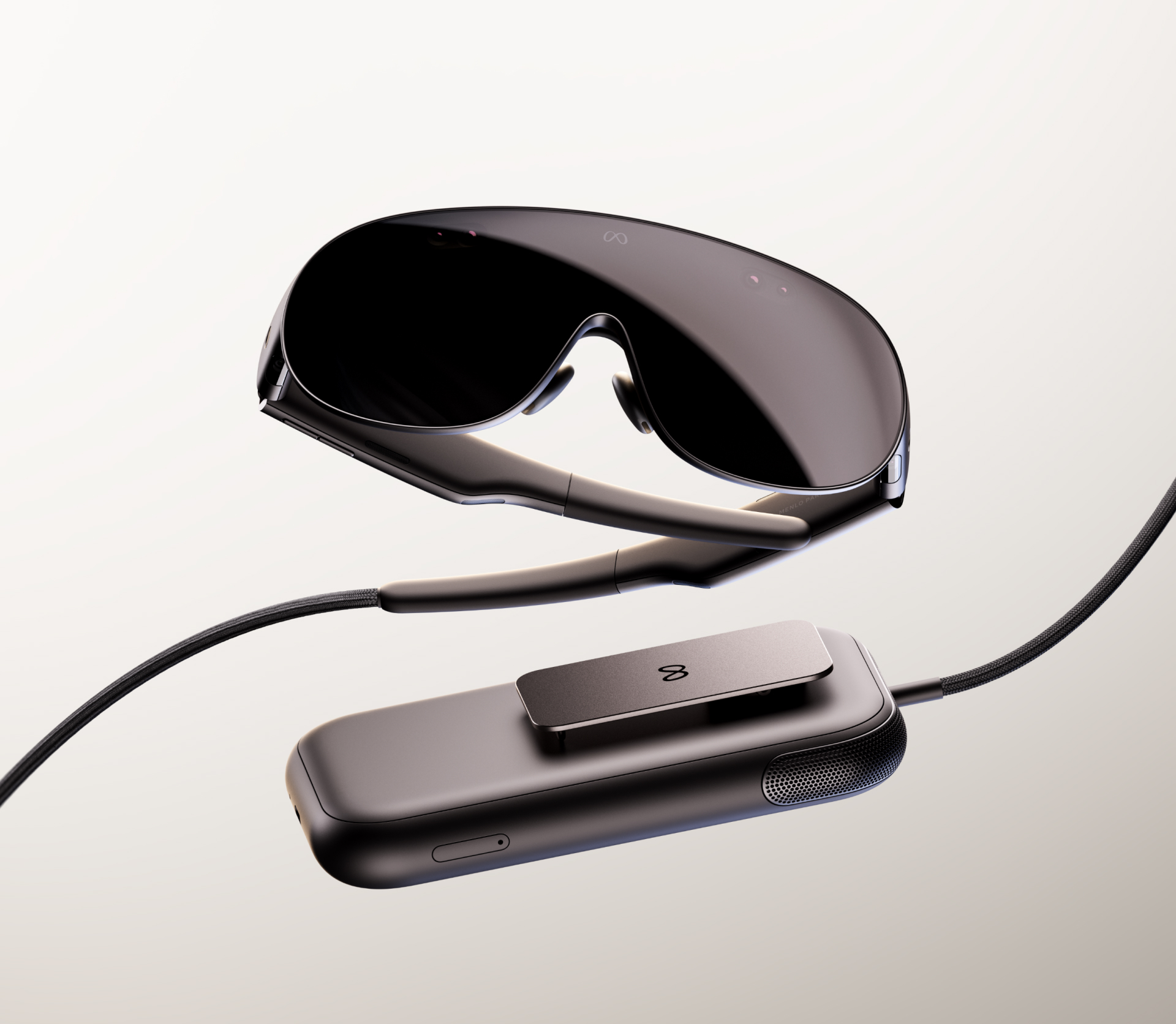 Meta VR Glasses and their separate compute puck connected by a tether.