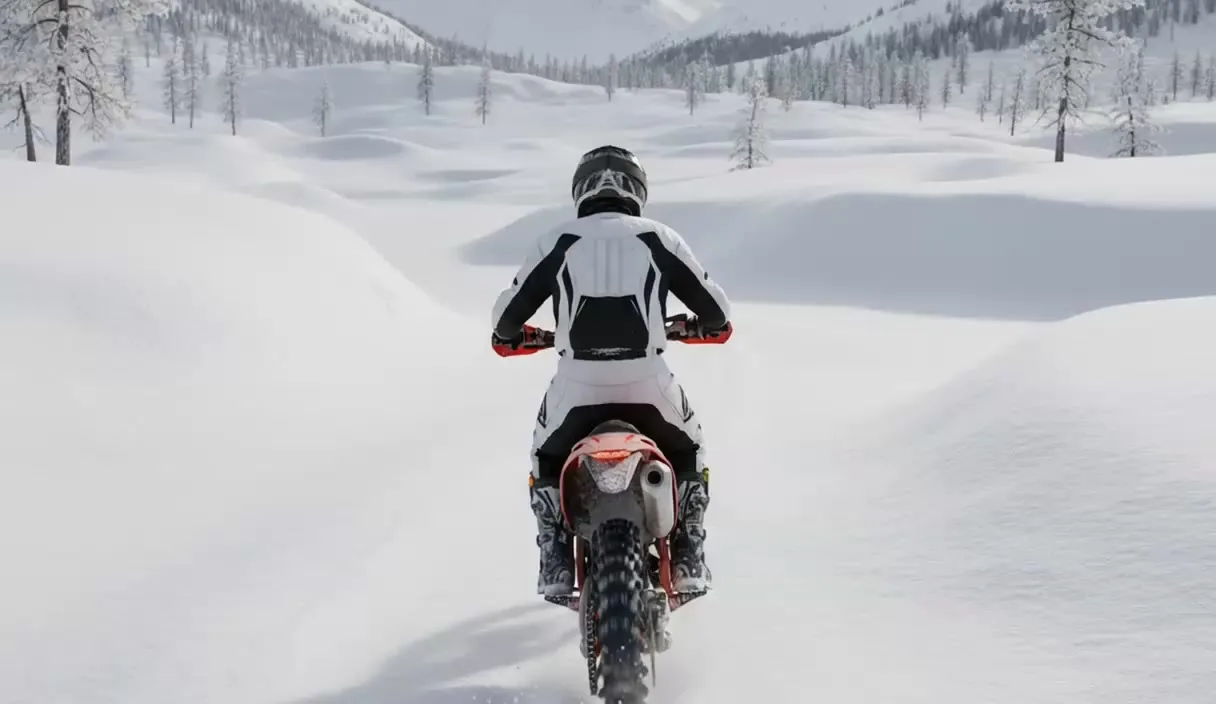A dirt bike rider in a snowy generated environment from Runway’s demo