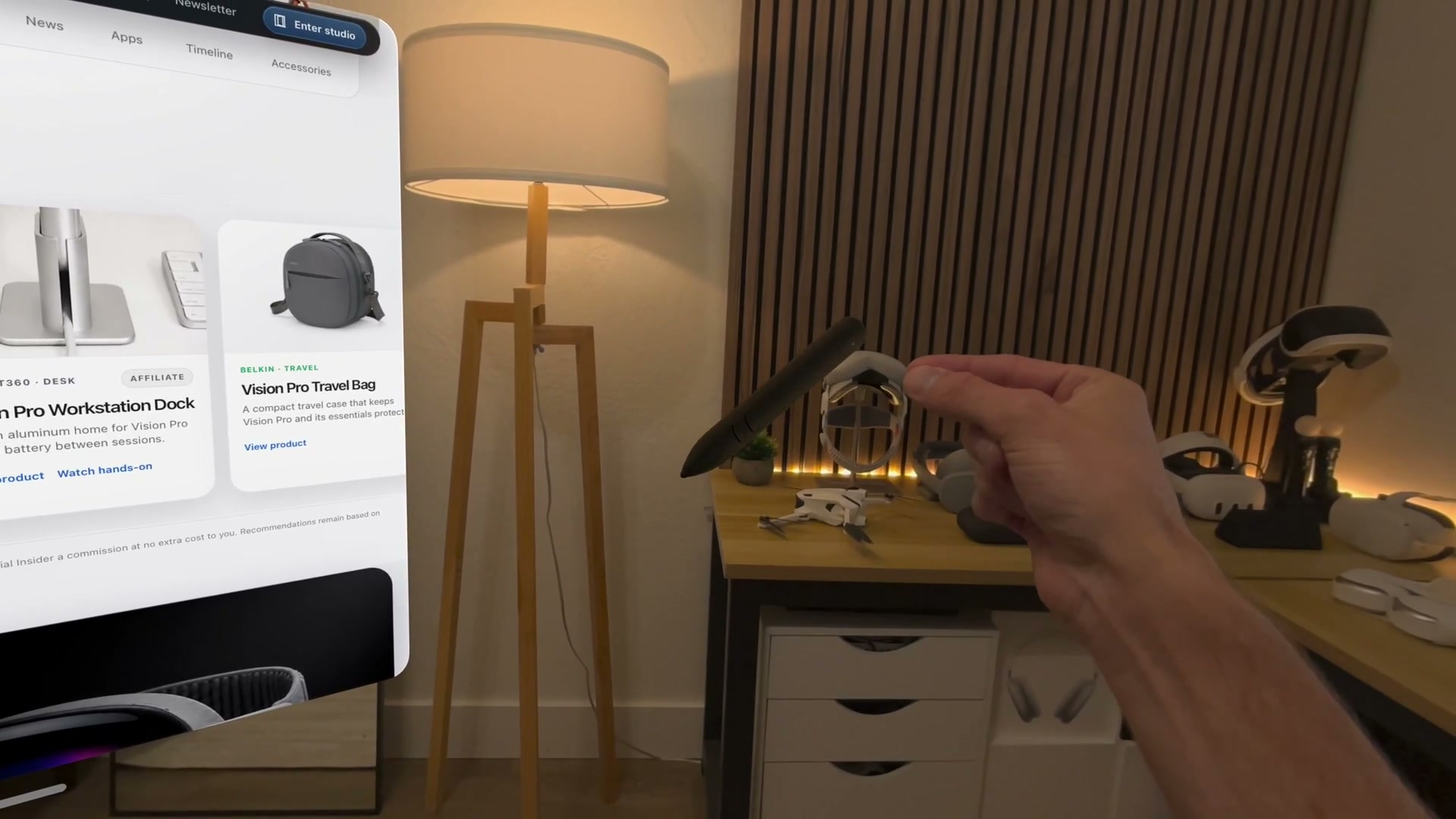 A hand pinches an interactive 3D model beside the Spatial Insider website in Safari on Apple Vision Pro