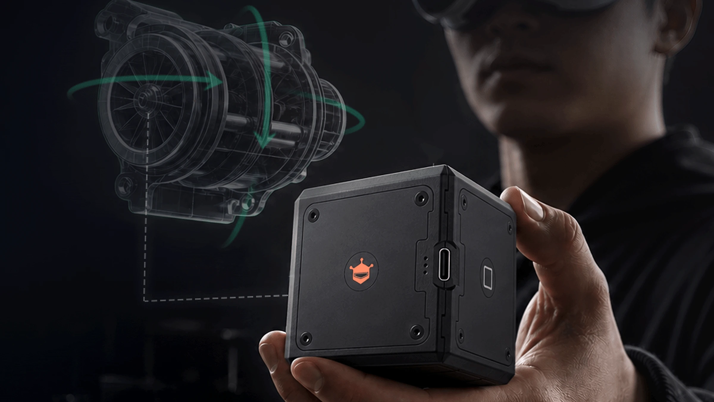 A person wearing Apple Vision Pro holds the black seeMote Cube with a digital object anchored to it