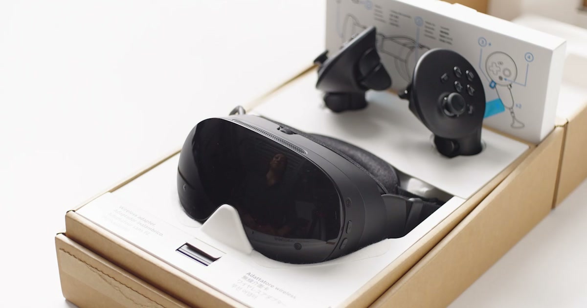 Steam Frame headset and two controllers arranged inside the open retail box