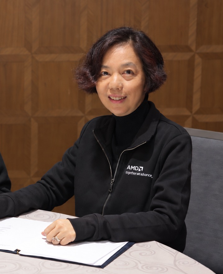 Fei-Fei Li wearing an AMD jacket at the World Labs agreement signing