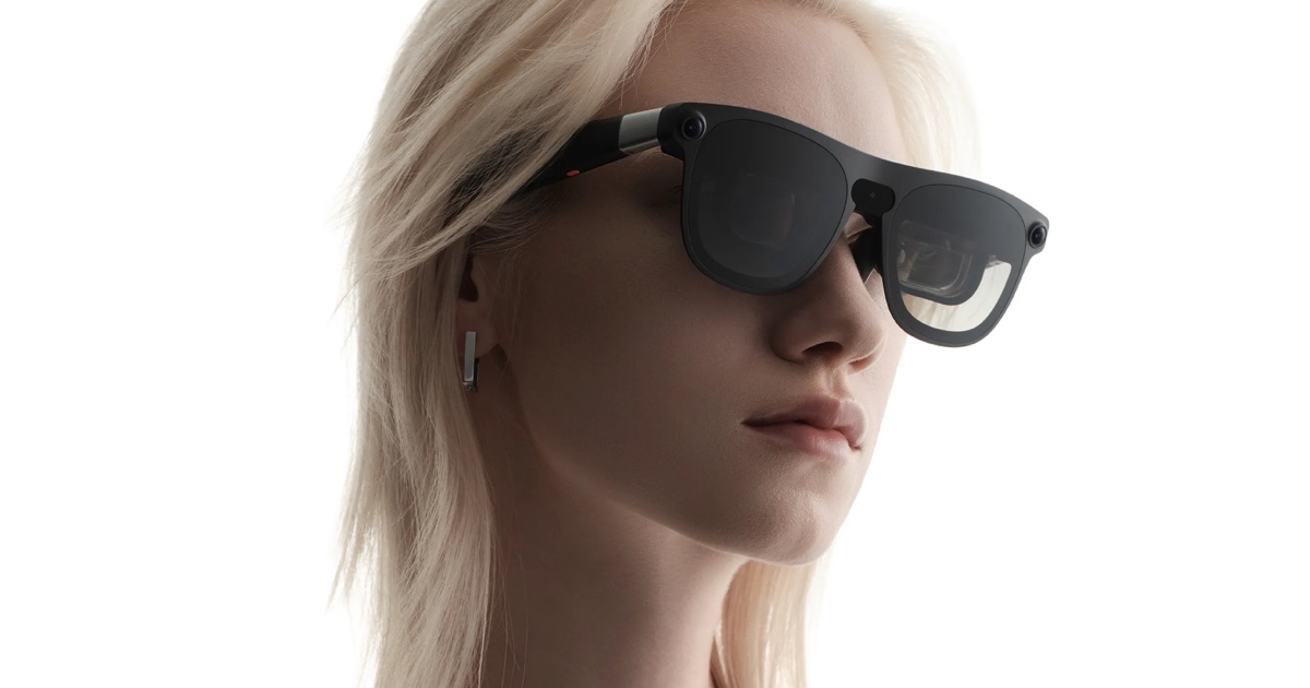 Model wearing black XREAL AURA Android XR glasses against a white background